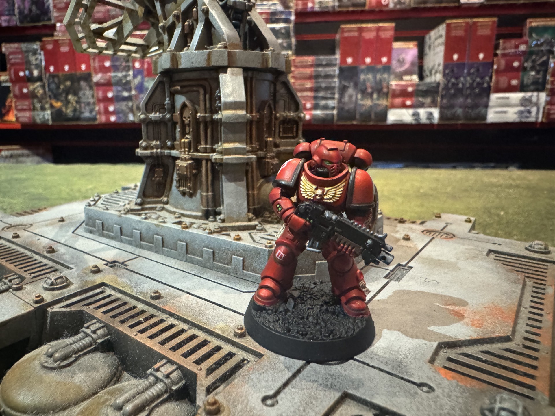 Red Blood Angels Space Marine painted with Warhammer Tone Pro sample paints, standing beside battlefield scenery.